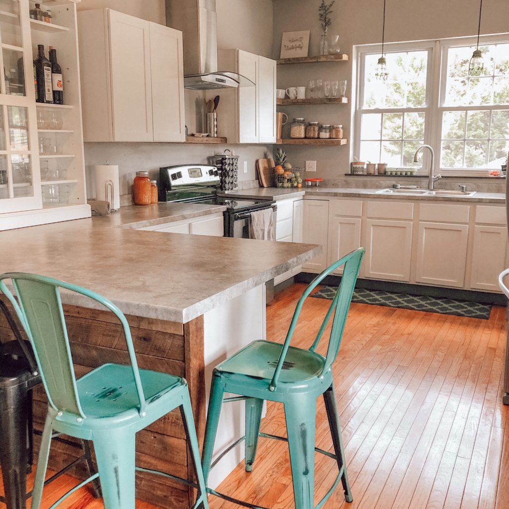 modern farmhouse kitchen with teal counter stools and simple decor