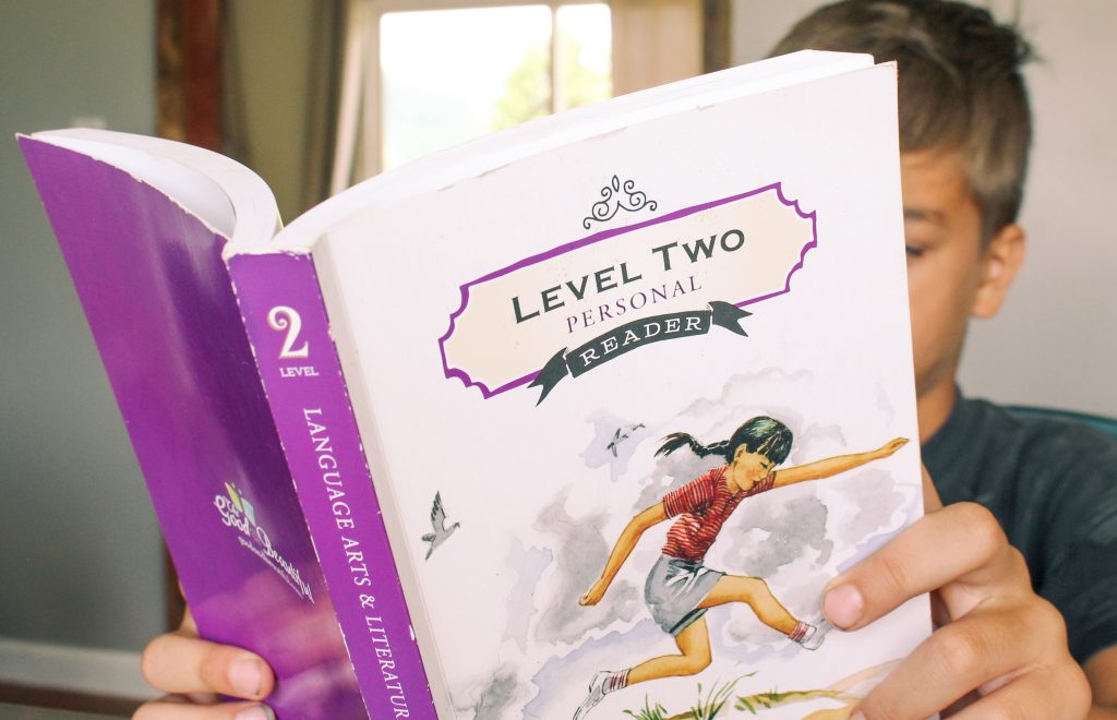 child reading the good and the beautiful level two personal reader