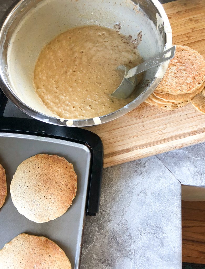 sourdough pancakes cooking with batter
