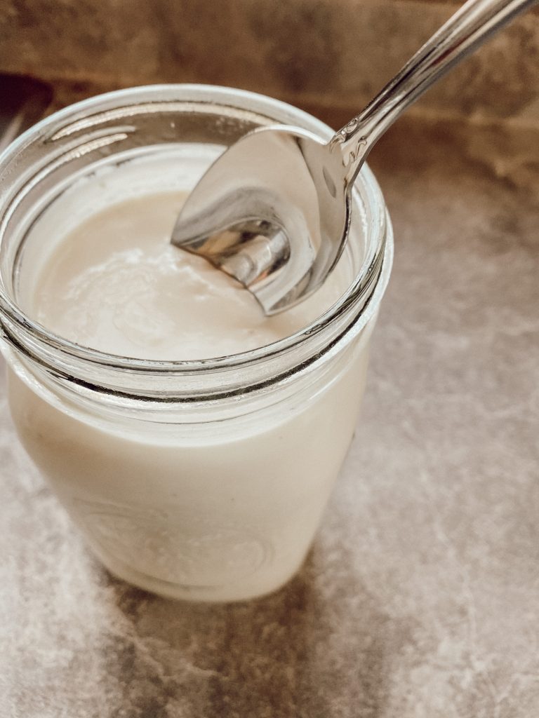 spoon dipped in homemade yogurt