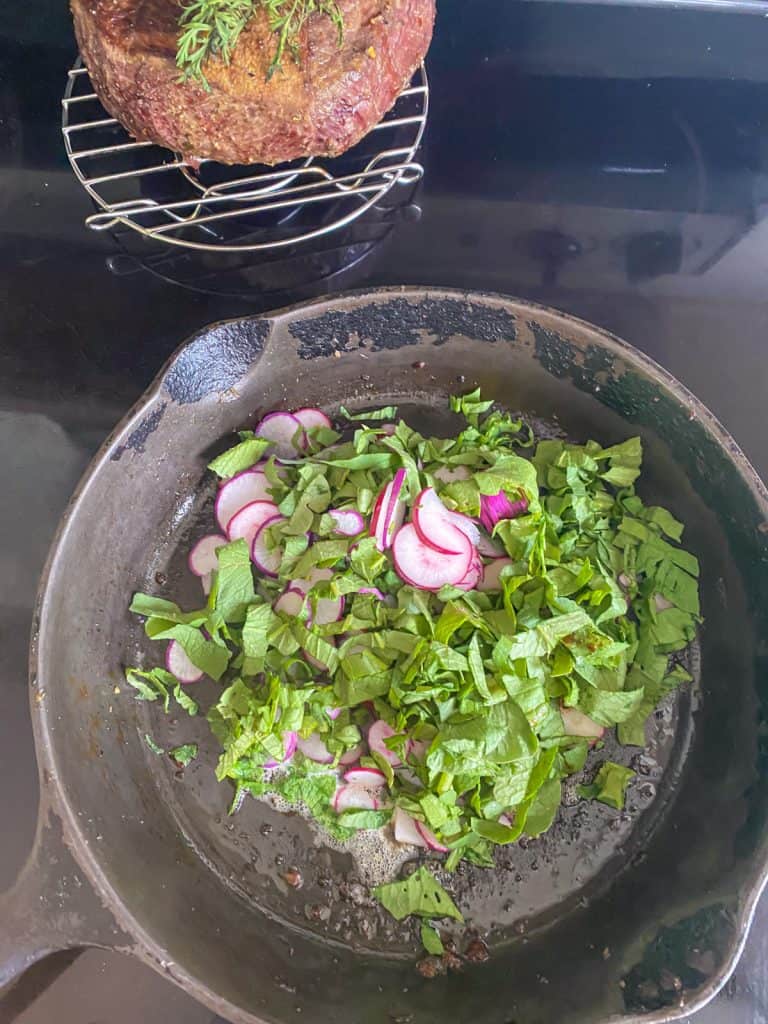 thinly cut radish with radish greens in cast iron skillet