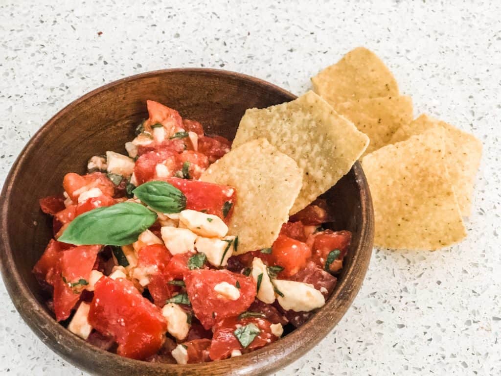 summer bruschetta dip with tortilla chips as vegetable side dish