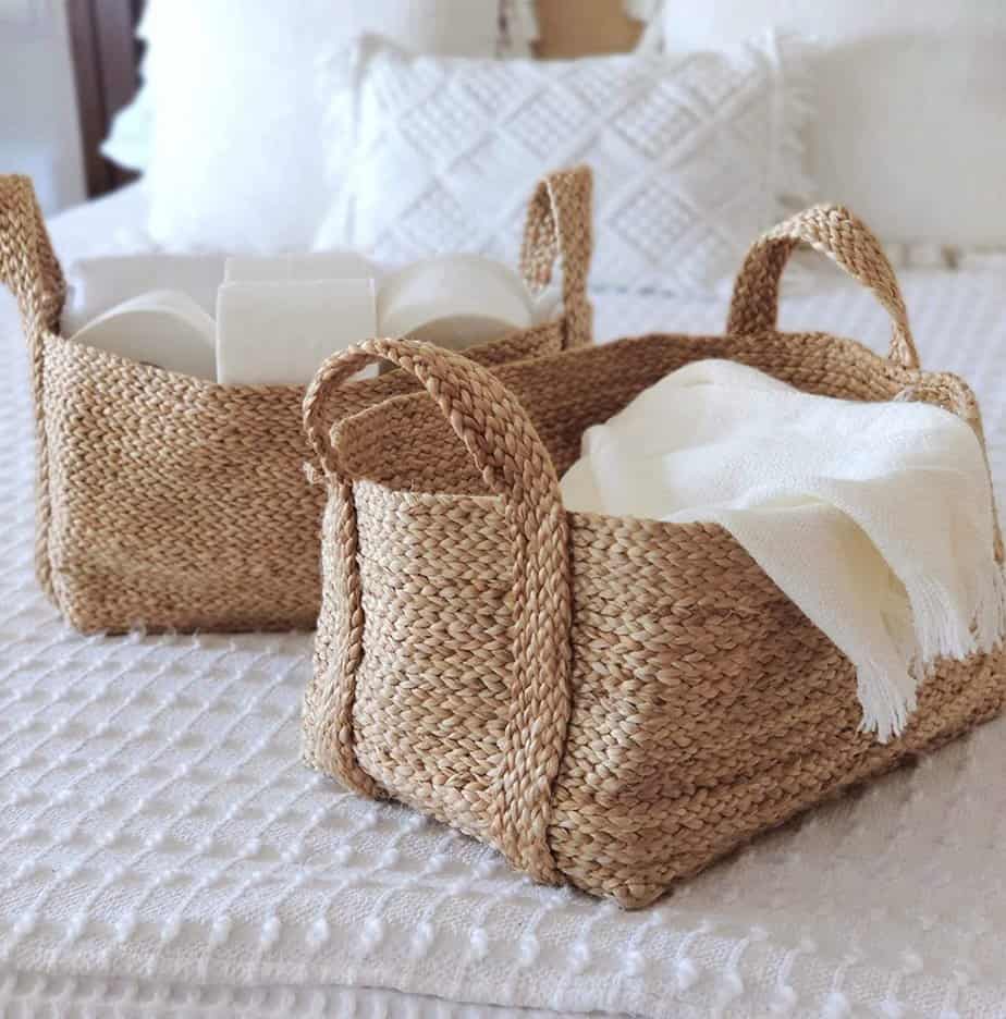 jute baskets with toilet paper and linens inside