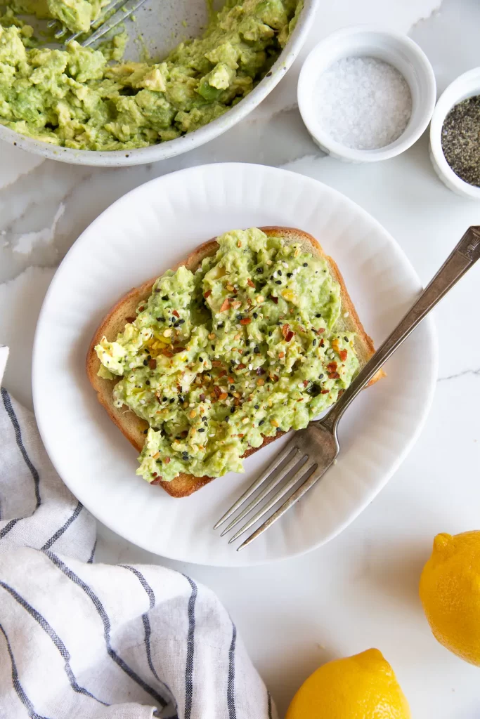smashed avocado and seasoning on sourdough toast