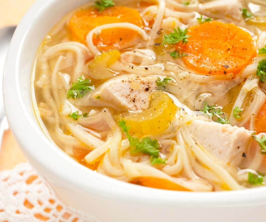 chicken noodle soup in white bowl
