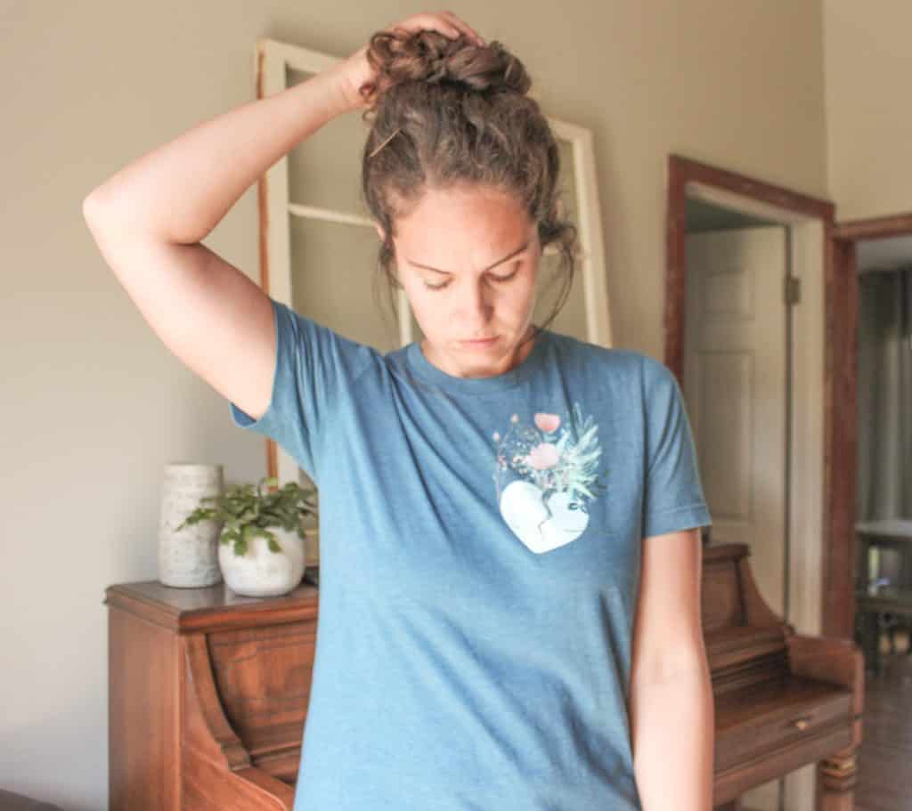 woman wearing blue t shirt in front of piano