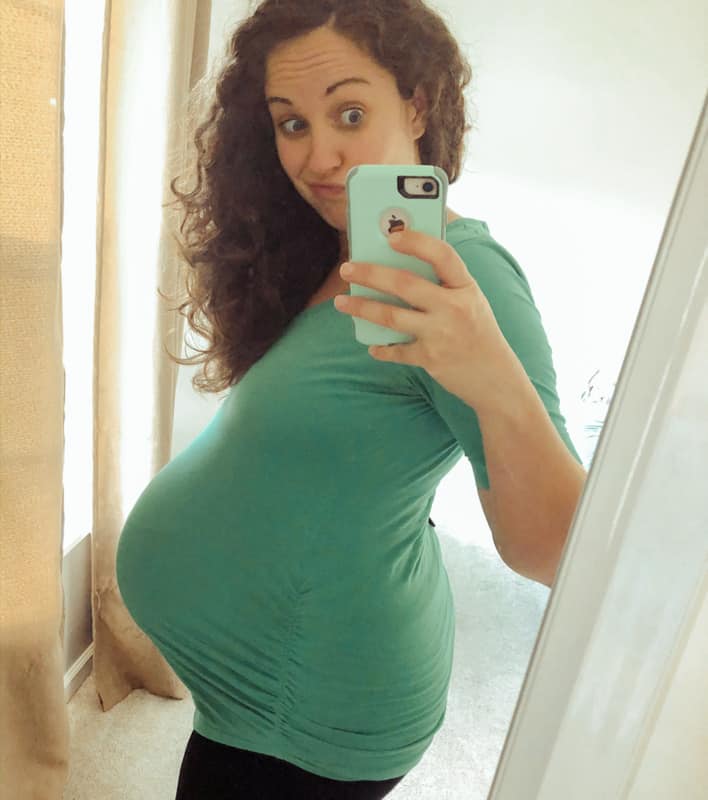 woman wearing blue 9 months pregnant selfie