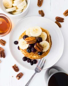 banana pancakes with pecans and blueberries and bananas