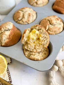 gluten free sourdough muffins in pan with butter