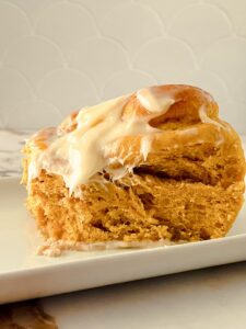 pumpkin cinnamon roll topped with glaze